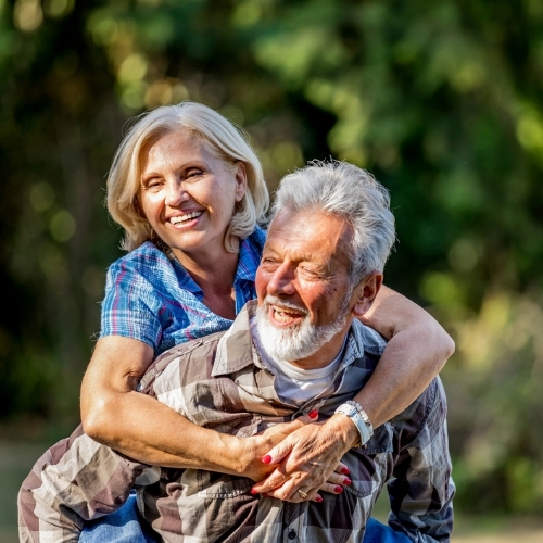 elderley couple having a piggy back ride in the spring while enjoying a promotional spring offer at the white hart