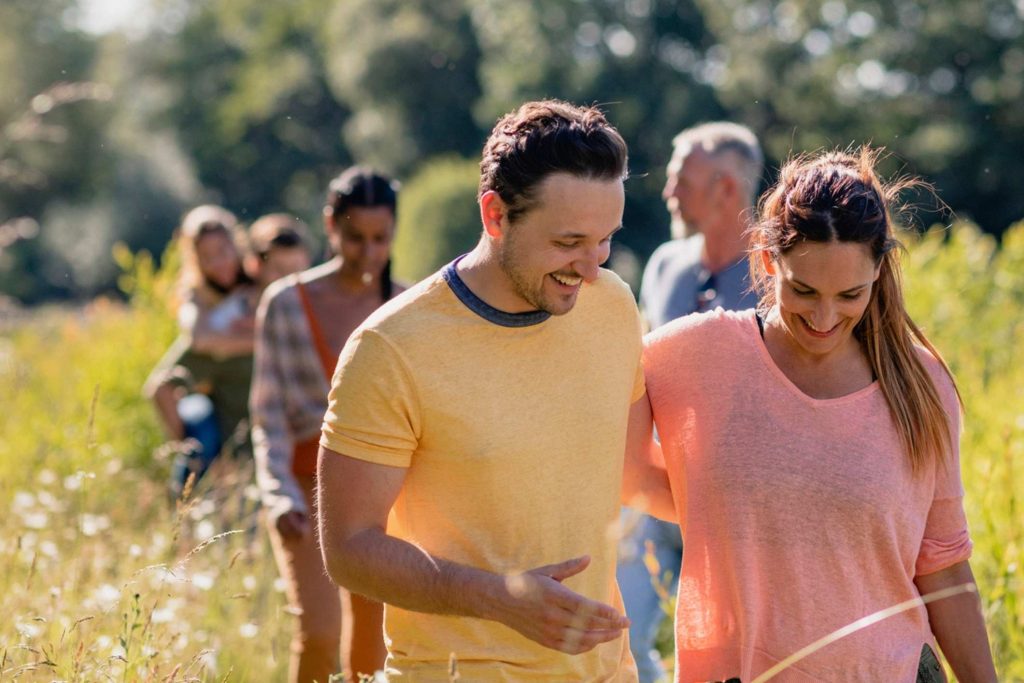 Couples enjoying a summer walk along the winchcombe way while staying at the white hart inn.
